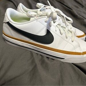 Nike White and Black Sneakers with Gold Trim
